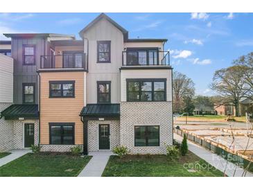 Modern townhome featuring varied exterior materials, multiple balconies, and manicured landscaping at 722 Falling Oak Aly # 20, Huntersville, NC 28078