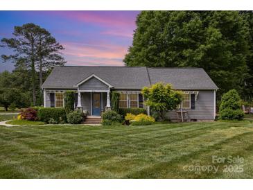 Charming home with well-maintained lawn, mature trees and established landscaping at 878 Cold Springs Rd, Concord, NC 28025