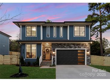 Beautiful modern two-story home with blue siding, stone accents, and a sleek black garage door at 554 W Cama St, Charlotte, NC 28217