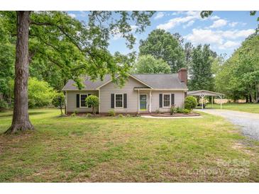 Charming single-story home with neutral siding, black shutters, a covered carport, and a well-manicured lawn at 604 Chaney Rd, Monroe, NC 28110