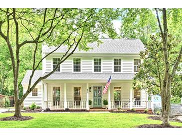 Charming two-story home with a well-manicured lawn, white siding, and a welcoming front porch at 611 Heathermoor Ct, Charlotte, NC 28209