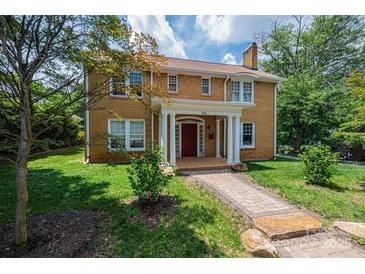 Charming brick two-story home with red front door and well-maintained front yard at 625 2Nd Ne St, Hickory, NC 28601