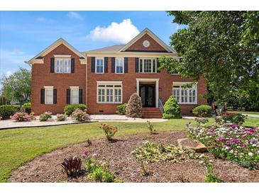 Inviting brick home with manicured lawn and garden at 11917 Chevis Ct, Charlotte, NC 28277