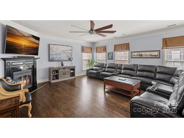 Large living room with hardwood floors, fireplace, and comfortable seating at 1948 Winpole Ln, Charlotte, NC 28273