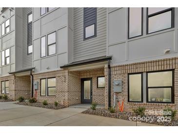 Modern townhome featuring a stylish brick facade with a gray and white color scheme at 834 Van Every St, Charlotte, NC 28205
