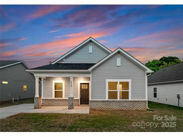 Charming single-story home with gray siding, brick accents, and a cozy front porch at 1619 Martin Ave, Gastonia, NC 28052