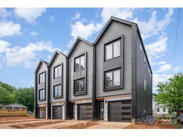 Modern townhome exteriors featuring gray siding, black trim, garages, and professionally landscaped front yards at 208 Mattoon St, Charlotte, NC 28216