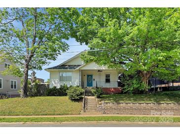Charming single-story home with a blue front door, mature trees, and landscaped front yard at 209 S Ransom St, Gastonia, NC 28052