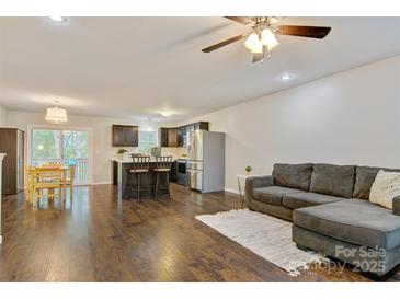Open-concept living space featuring hardwood floors, modern furnishings, and a seamless flow to the kitchen at 2835 24Th Street Ne Dr, Hickory, NC 28601