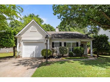 Charming single-story home with a well-maintained lawn and attached garage, offers cozy suburban living at 16117 Wrights Ferry Rd, Charlotte, NC 28278