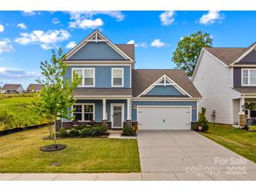 Charming two-story home with a well-manicured lawn and a two-car garage in a Gathering-friendly neighborhood at 194 Canada Dr, Statesville, NC 28677