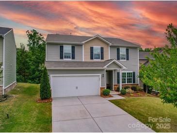 Charming two-story home with a well-maintained lawn, a two-car garage, and a cozy front porch at 2037 Christopher Wood Ct, Indian Land, SC 29707