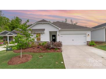 Charming home with a two-car garage, lovely landscaping, and a manicured lawn at 2202 Cherrybark Ct, Denver, NC 28037