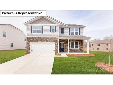 Charming two-story home featuring a stone facade, covered porch, and a well-manicured lawn at 3412 Lacebark Ln, Gastonia, NC 28056