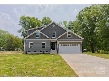 Charming two-story home with a well-manicured lawn and attached two-car garage at 4006 Scarlet Dr # 29, Matthews, NC 28104