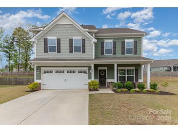 Charming two-story home with a well-manicured lawn, attached garage and beautiful landscaping at 6070 Trinity Crossing Cir, Kannapolis, NC 28081