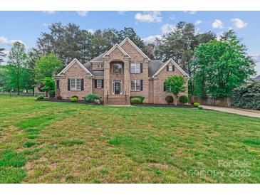 Elegant brick home with a meticulously maintained lawn and mature landscaping at 7887 Mountain Shore Dr, Sherrills Ford, NC 28673