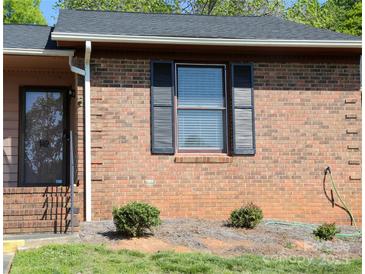 Brick townhouse exterior with dark shutters, a brown roof, and a dark-trimmed front door at 149 Glenwood Dr, Rock Hill, SC 29732