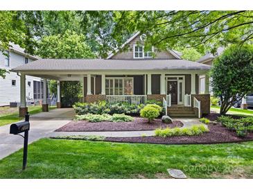 Charming home exterior featuring a covered porch, well-manicured landscaping, and a welcoming entrance at 2311 Club Rd, Charlotte, NC 28205