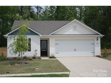 Charming single-story home featuring a two-car garage, black door, and well-manicured front lawn at 3138 Maple Ridge Dr, Gaston, NC 28052