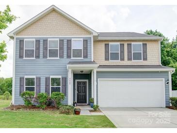 Charming two-story home featuring a two-car garage, gray shutters, and a well-manicured front yard at 4008 Houndscroft Rd, Indian Trail, NC 28079