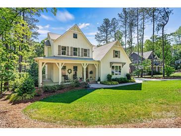 Charming home featuring a well-maintained lawn, inviting front porch, and tasteful landscaping at 4290 Palm Dr, Denver, NC 28037