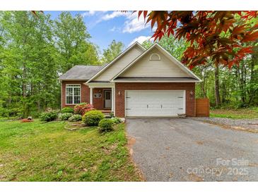 Charming single-story brick home with attached garage, landscaped yard, and mature trees at 4927 Gateway Dr, Claremont, NC 28610