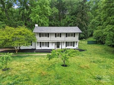 Charming two-story home with a balcony and beautifully landscaped front yard at 7531 Linda Lake Dr, Charlotte, NC 28215