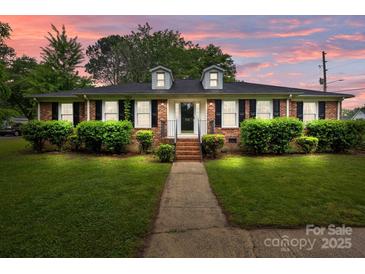 Charming brick home with well-manicured lawn and shrubbery, featuring dormer windows and a welcoming walkway at 101 Wynnchester Rd, Gastonia, NC 28056
