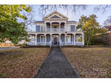 Charming two-story home featuring a covered front porch and classic architectural details at 121 York St, Chester, SC 29706