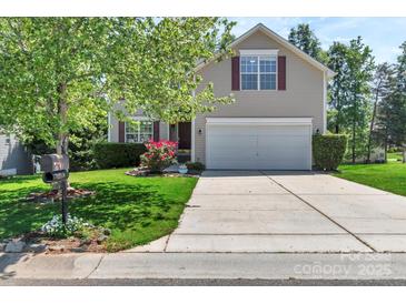 Charming two-story home featuring a well-maintained lawn and a two-car garage at 1218 Faversham Ln, Rock Hill, SC 29730