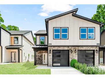 Charming two-story house features modern design, stone accents, and a well-manicured lawn at 2015 Wilson Ave, Charlotte, NC 28208