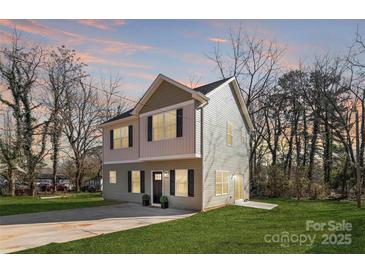Charming two-story home with neutral siding, manicured lawn and inviting curb appeal at 2123 Gemway Dr, Charlotte, NC 28216