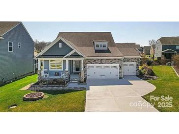 Charming single-Gathering home boasts a two-car garage and beautifully landscaped front yard at 4315 Innisfree Ct, Indian Trail, NC 28079