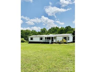 Charming single-story home with a front porch, nestled in a green lawn and wooded area at 645 E Border E Rd, Rock Hill, SC 29730