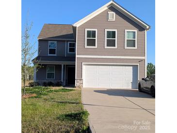 Charming two-story home with a two-car garage and well-maintained lawn and lovely curb appeal at 804 Yorkshire Dr, Albemarle, NC 28001