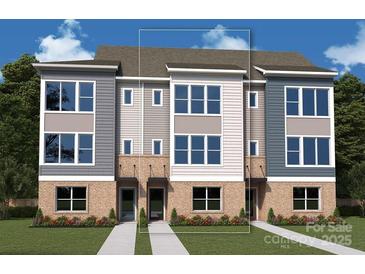 Modern townhome exterior with brick base, large windows, and neutral-toned siding at 1112 Bismuth Ln, Charlotte, NC 28211