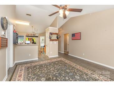Open-concept living room showcases wood-look floors and a seamless transition into the kitchen area at 228 Grayland Rd, Mooresville, NC 28115