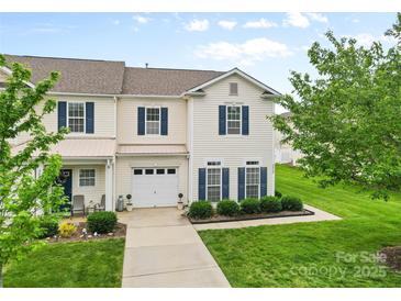 Charming two-story townhome with well-manicured lawn, attached garage, and inviting curb appeal at 3030 Priory Ridge Dr, Fort Mill, SC 29707