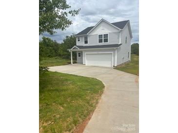 A charming two-story home with a gray exterior and an attached two-car garage at 405 Webb Rd, Shelby, NC 28152