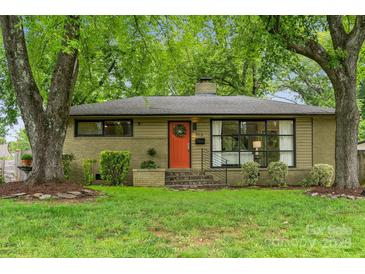 Charming ranch-style home with an orange front door, landscaped yard, mature trees, and black framed windows at 513 Inwood Dr, Charlotte, NC 28209