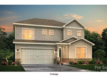 Charming two-story home showcasing a symmetrical facade and a two-car garage at 7073 Stella Pl, Stanley, NC 28164