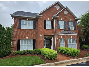 Beautiful two story red brick home featuring dark shutters and manicured landscaping at 800 Warrington Pl, Rock Hill, SC 29732