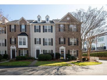 Charming townhomes with brick and siding exteriors, complemented by neat landscaping and dark shutters, offering inviting curb appeal at 8177 Millwright Ln, Charlotte, NC 28277