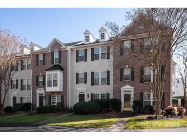 Attractive townhomes with well-manicured lawns and a mix of brick and siding facades create an appealing residential street view at 8177 Millwright Ln, Charlotte, NC 28277
