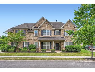 Charming brick home featuring a well-manicured lawn and traditional design elements under a clear blue sky at 117 Fellspoint Rd, Mooresville, NC 28115