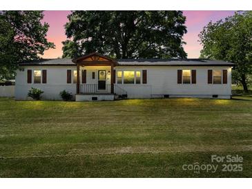 Charming ranch home featuring a covered front porch and spacious front yard at 135 Mcshag Dr, Kannapolis, NC 28081