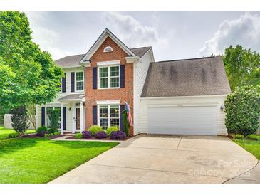Charming two-story home with well-manicured lawn and attached two-car garage at 15306 Gower Ct, Charlotte, NC 28278