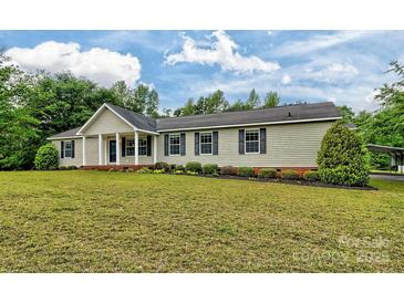Charming single-story home featuring a covered front porch and well-maintained landscaping at 1774 Wintertide Rd, Jefferson, SC 29718