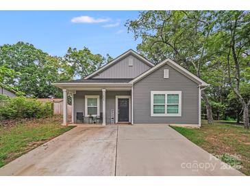 Charming gray home featuring a quaint front porch and well-maintained lawn at 205 E Maine Ave, Bessemer City, NC 28016